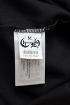 Size M clothing label inside black T-shirt with care information