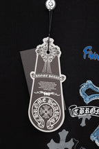 Black T-shirt close-up with white emblem hang tag and blue cross graphic