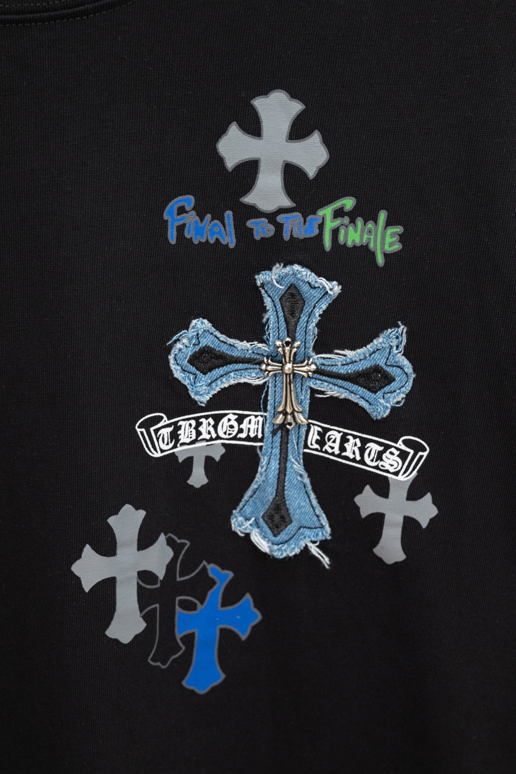 Black T-shirt chest graphic with blue cross and white cross symbols