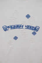 White T-shirt back with blue script graphic and raised flower appliques