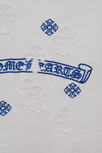 White T-shirt back detail with blue script ribbon and flower appliques