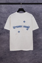 White T-shirt with large blue back graphic and small flower embroidery