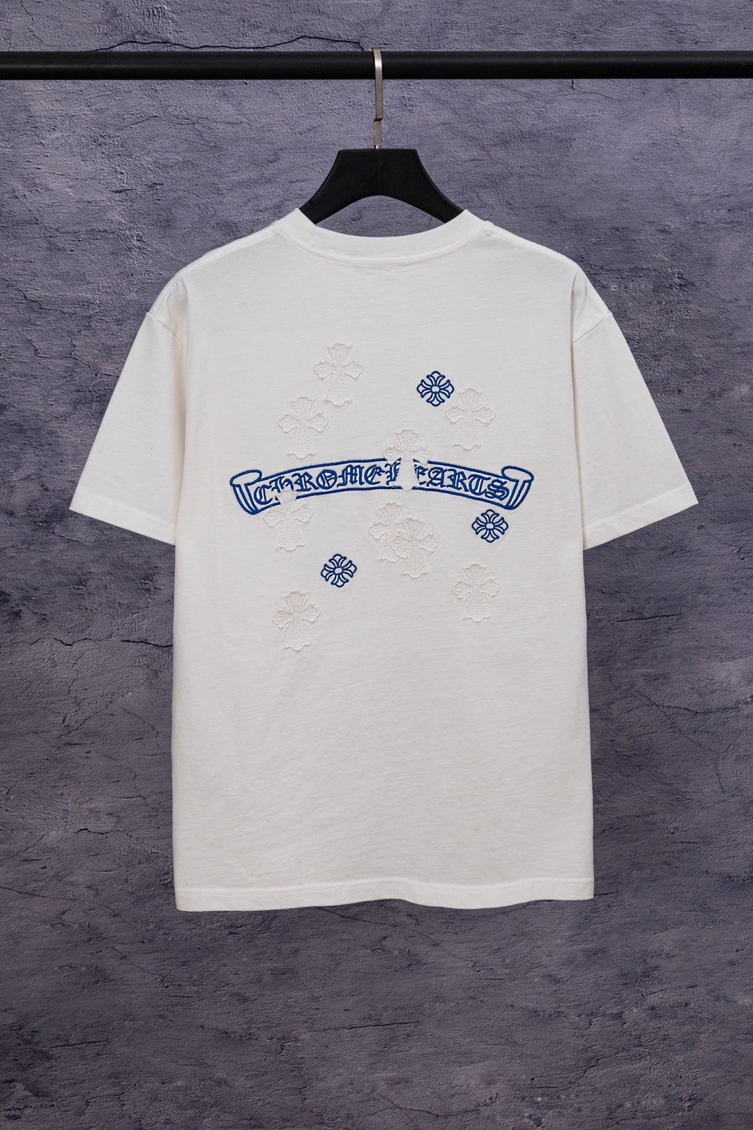 White T-shirt with large blue back graphic and small flower embroidery