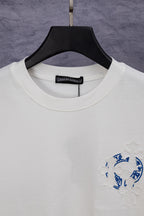 White crew-neck T-shirt with black neck label and blue logo patch