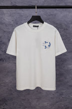 White short-sleeve T-shirt with blue chest graphic and small flower embroidery