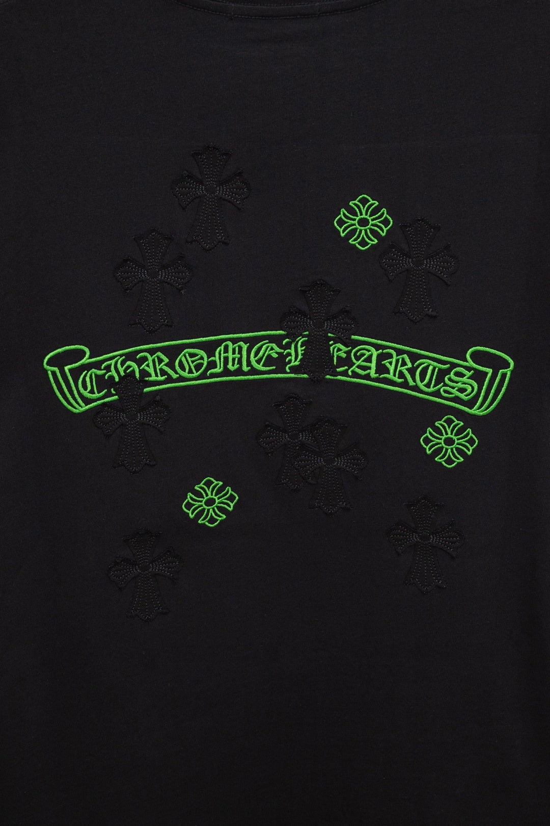 Black T-shirt back with neon-green logo text and small emblem icons