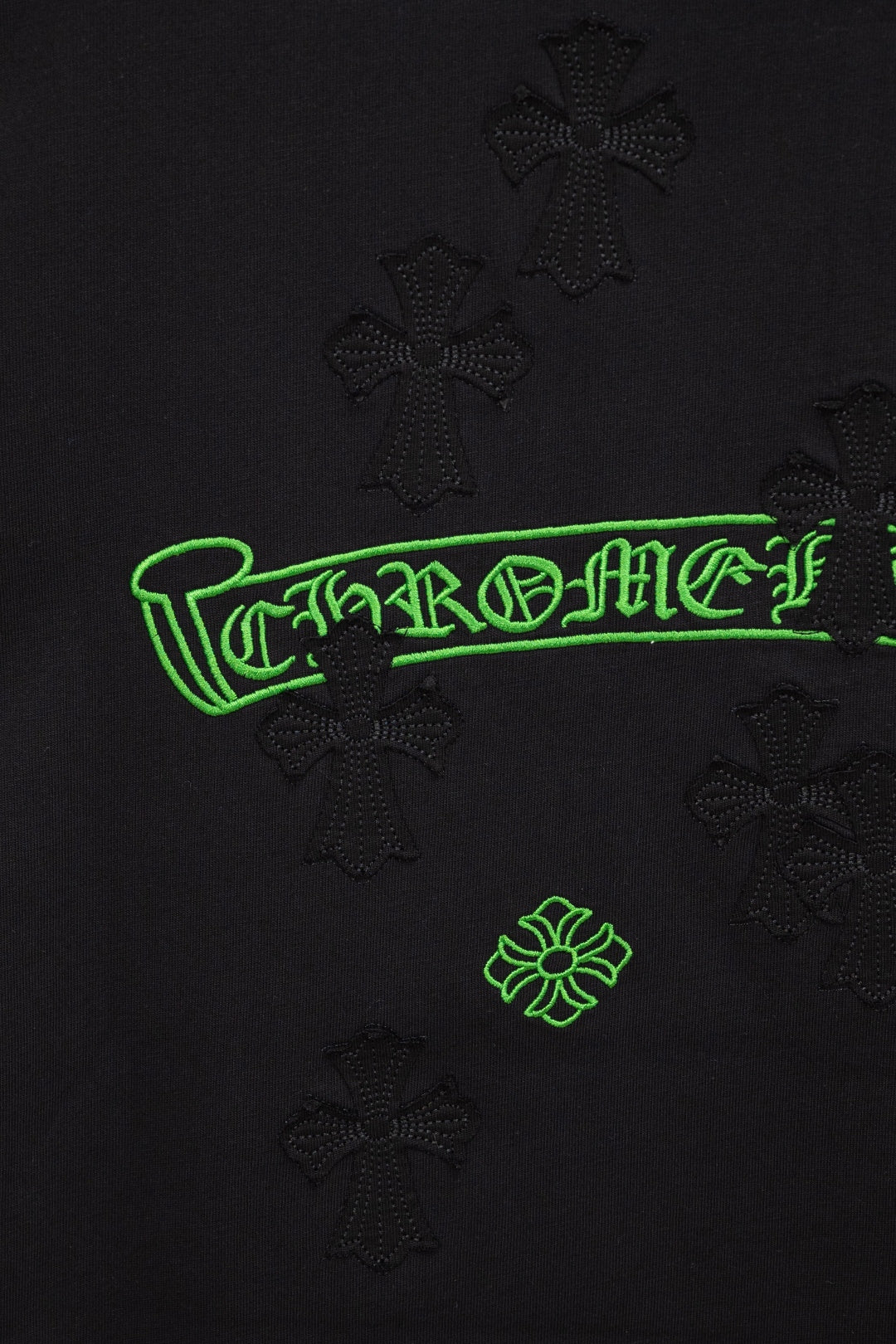 Black T-shirt logo with neon-green outlined lettering and small icons