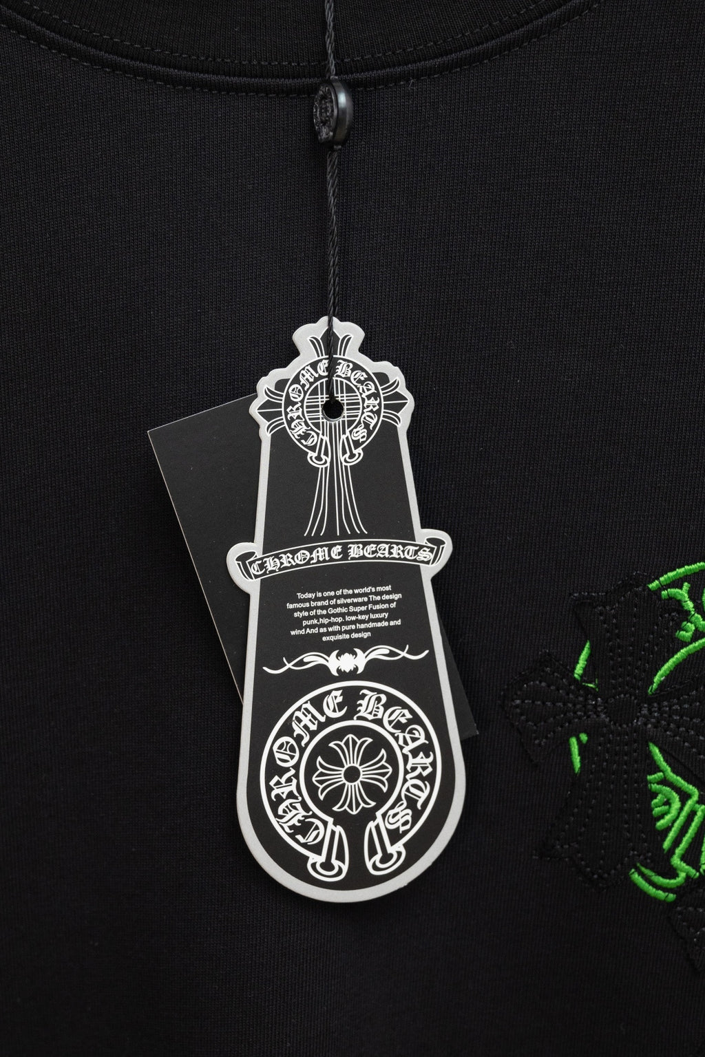 Black T-shirt with hanging white brand size tag near collar