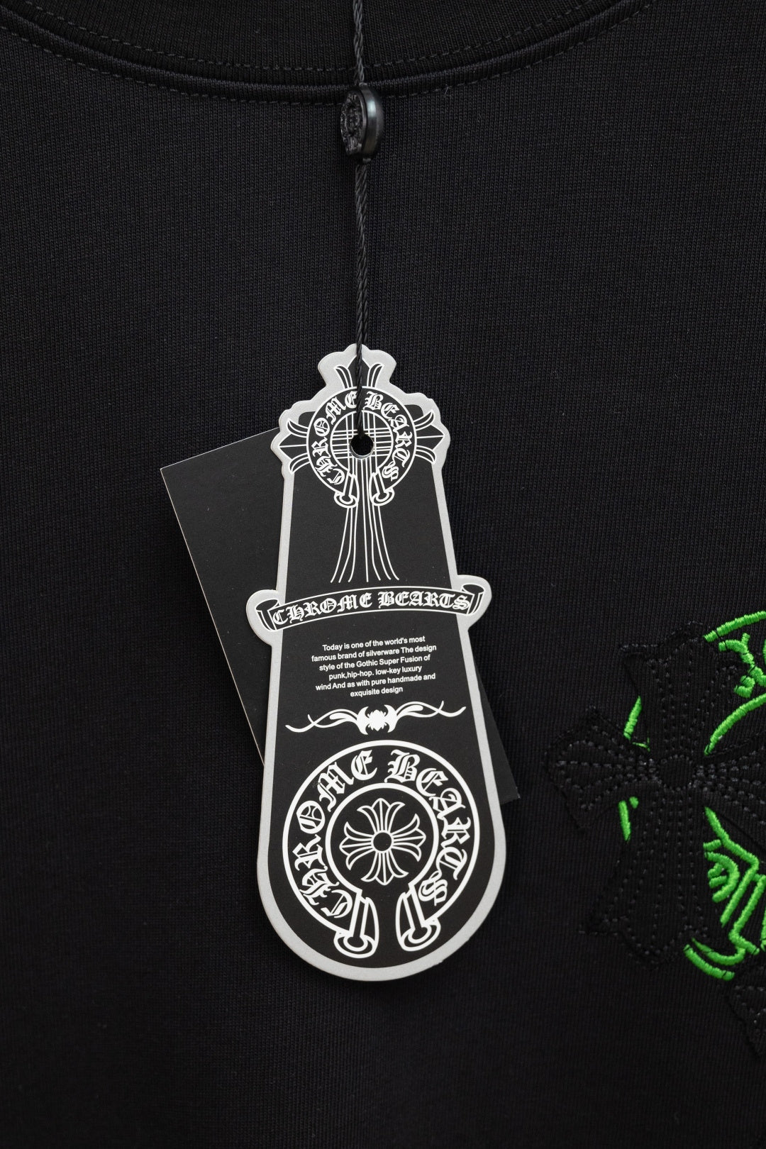 Black T-shirt with hanging white brand size tag near collar