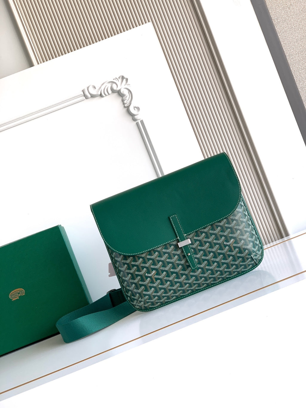 Goyard crossbody bag in green with geometric pattern, top flap and shoulder strap.