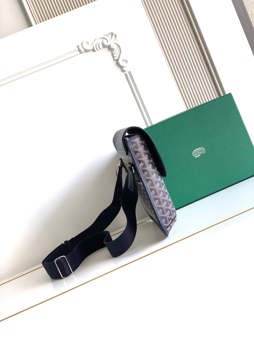 Navy monogram crossbody bag with adjustable strap and top flap opening
