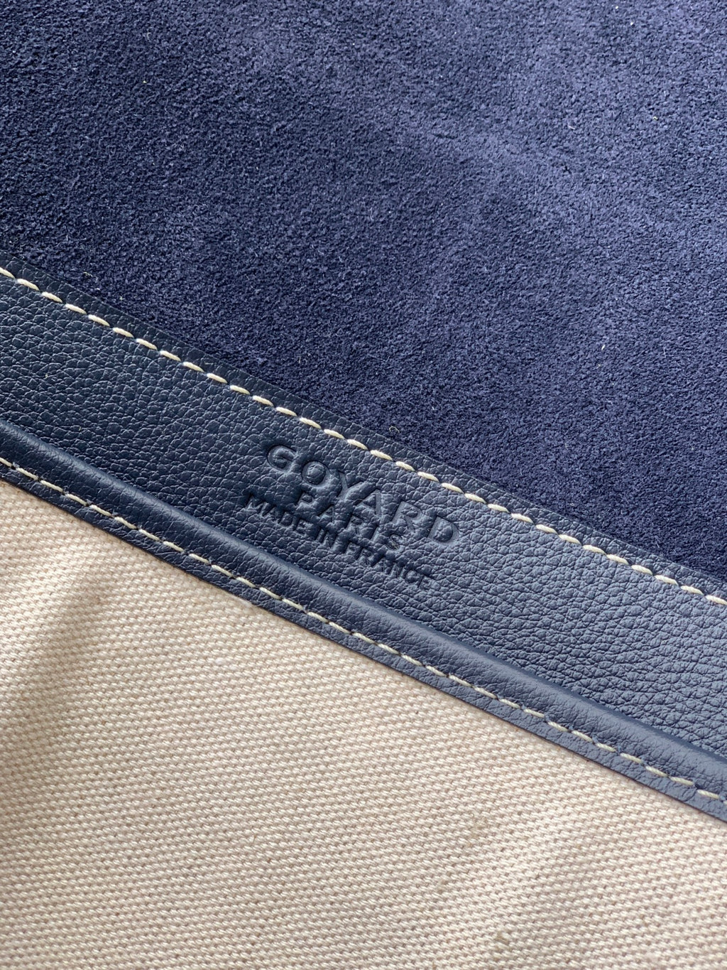GOYARD logo on navy leather trim with contrasting stitching