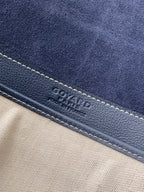 GOYARD logo on navy leather trim with contrasting stitching