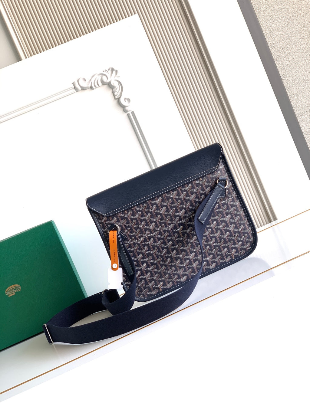 Navy monogram flap crossbody bag with zipper pull and front pocket zipper