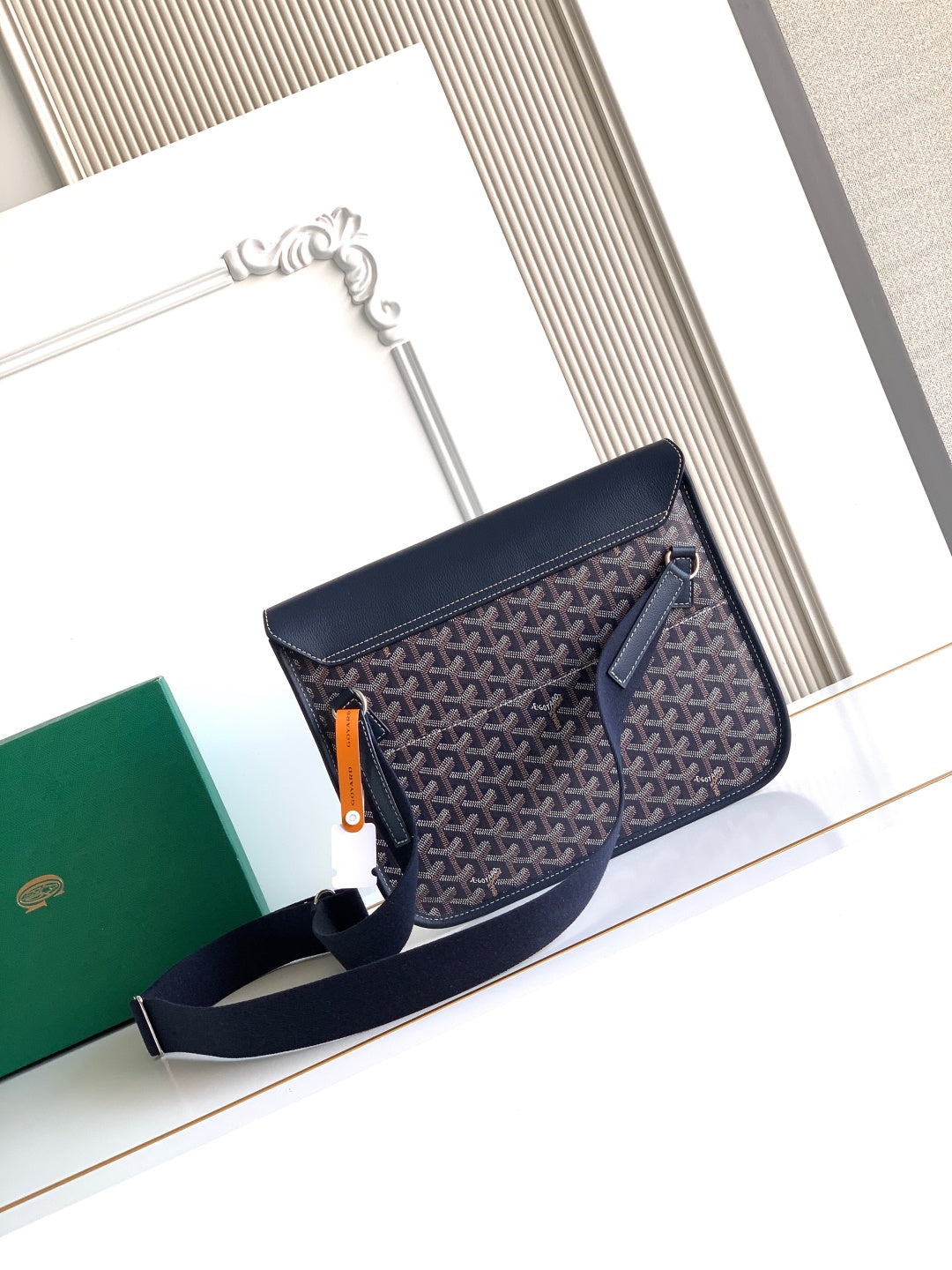 Navy monogram flap crossbody bag with zipper pull and front pocket zipper