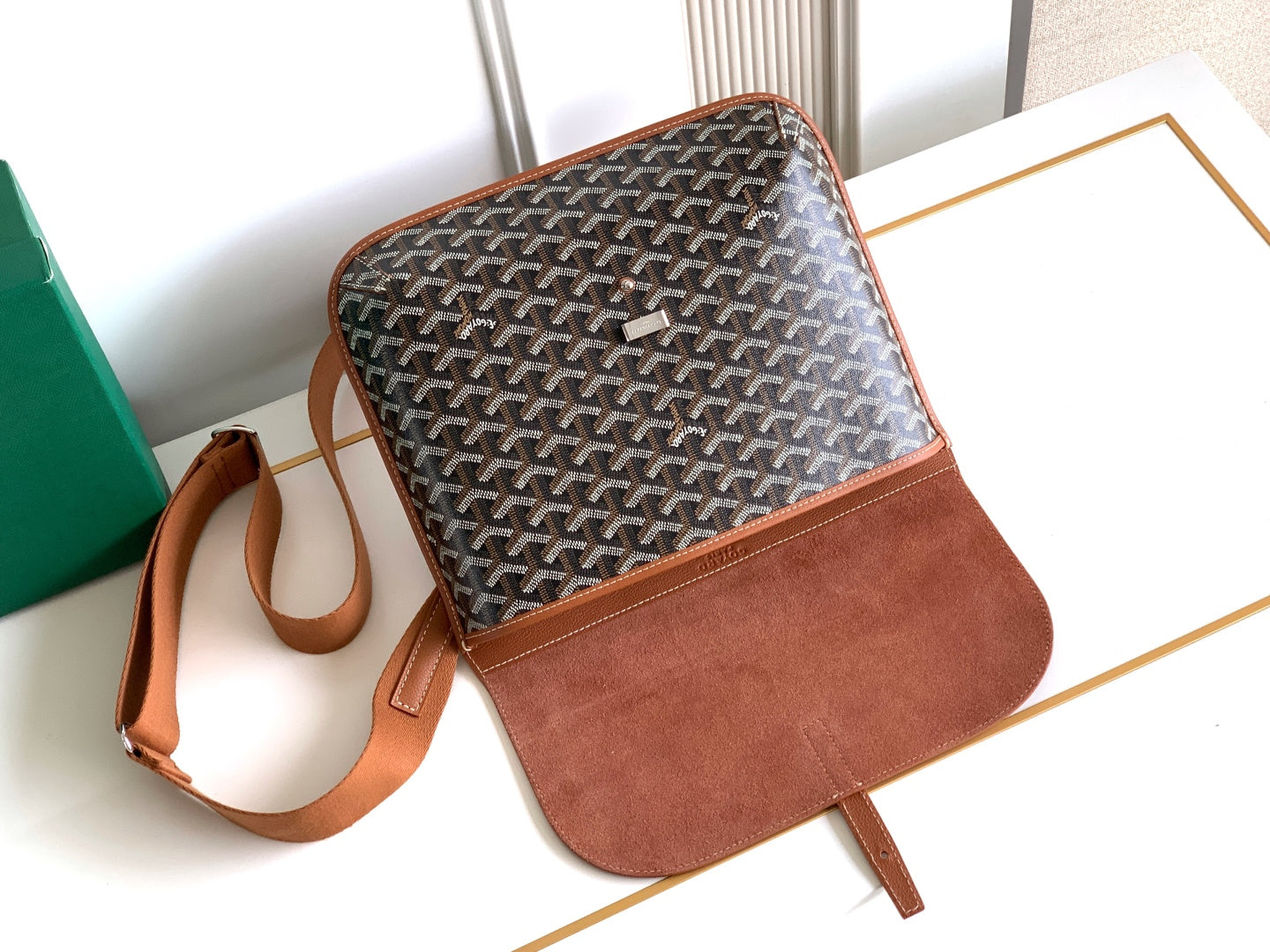 Goyard small crossbody bag with patterned canvas, tan front panel, and shoulder strap.