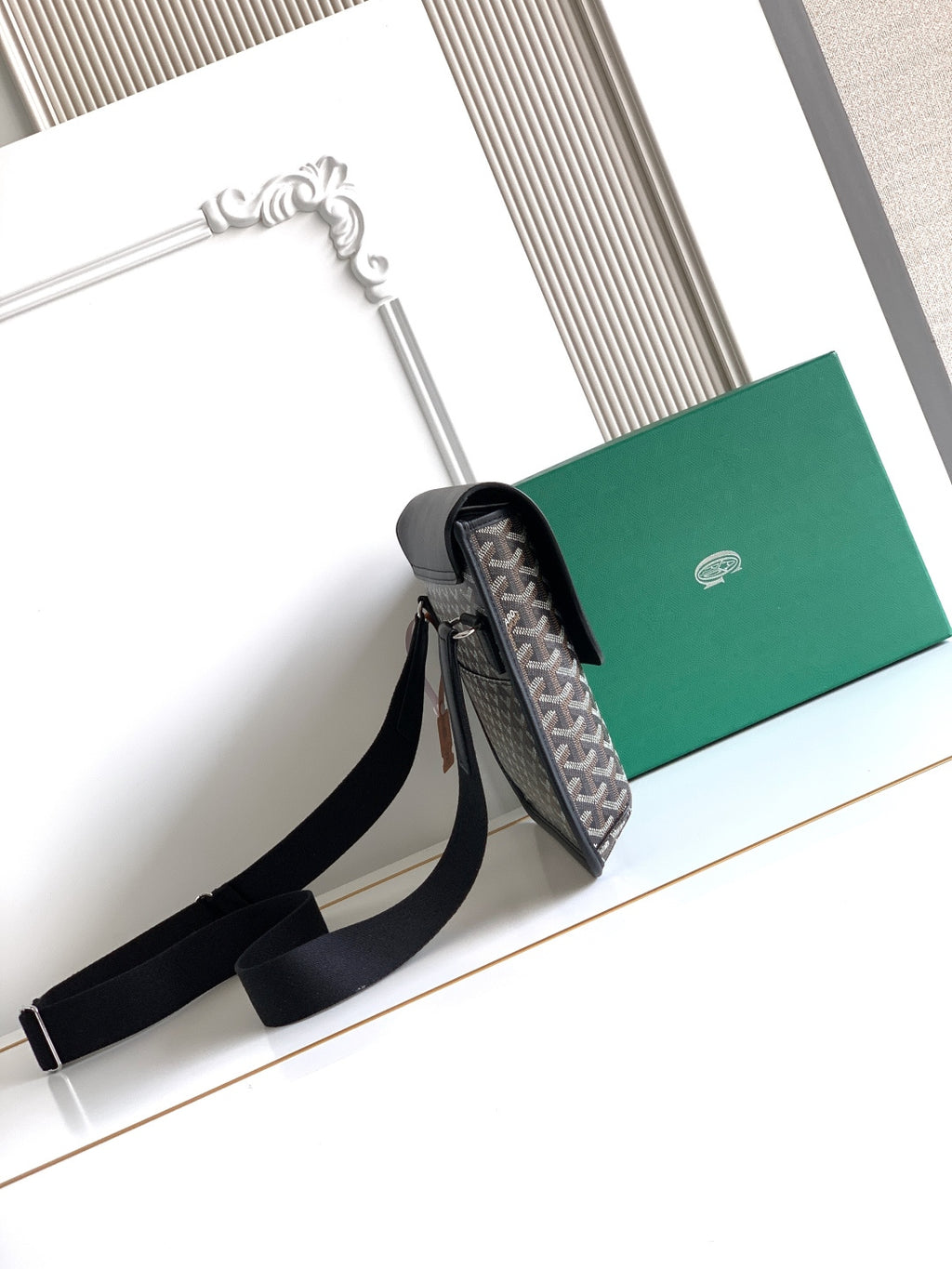 Goyard crossbody bag with top flap open, showing gray patterned interior and strap