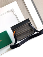 Goyard shoulder bag with black top flap, gray patterned body, and long adjustable strap