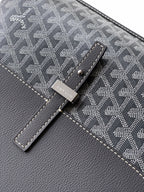 Goyard bag close-up of dark patterned flap with stitched details and metal clasp