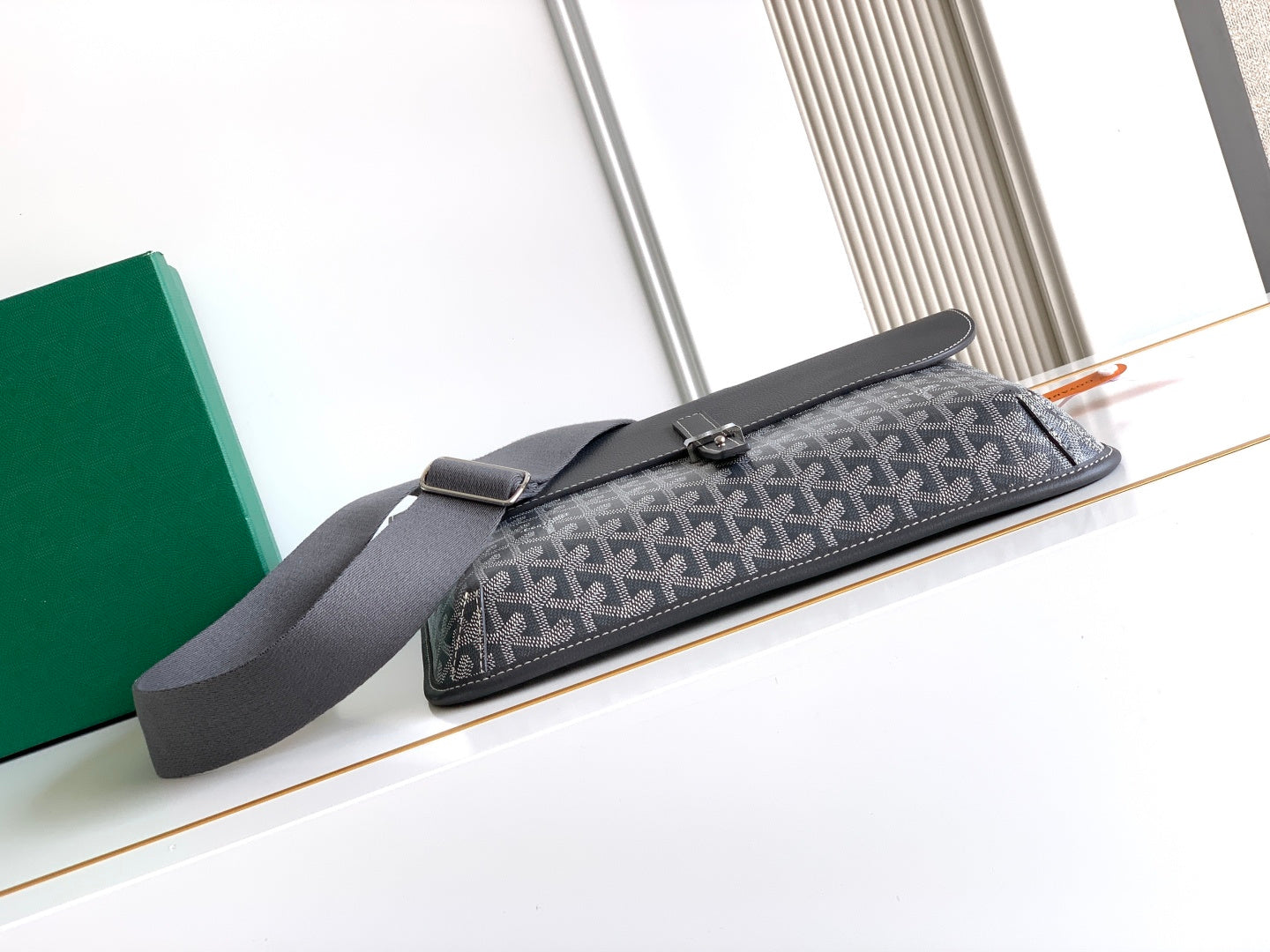 Goyard crossbody bag with long flap and dark gray shoulder strap