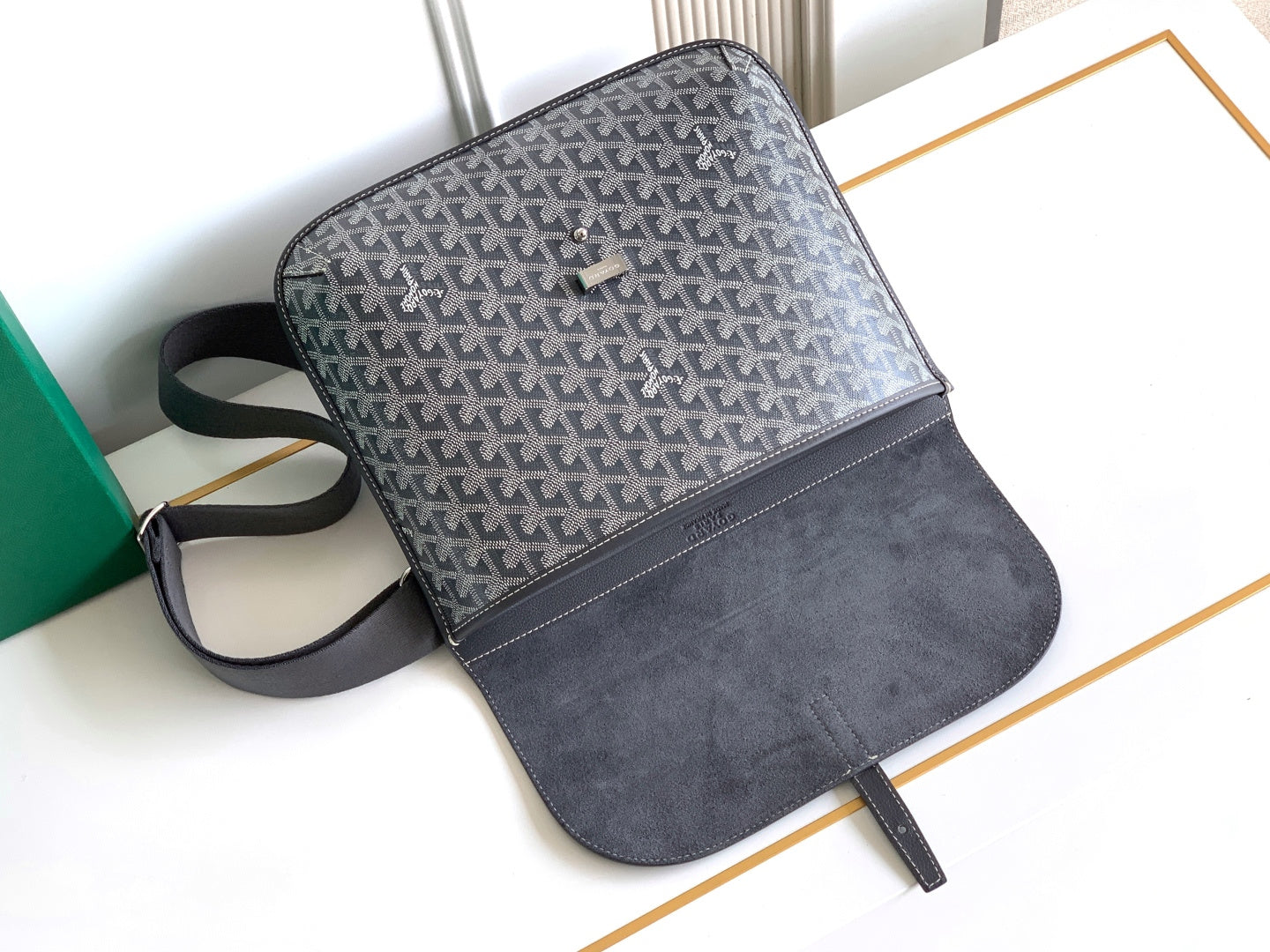 Goyard bag with gray patterned front, dark suede-style bottom, and strap