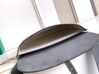 Goyard bag open top view with gray suede-like lining and curved flap