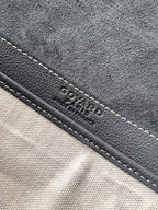 Goyard bag close-up of stitched edge with embossed Goyard text on dark trim