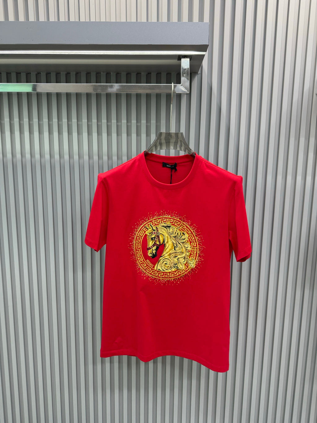 Versace red T-shirt with gold medallion lion graphic, crew neck and short sleeves