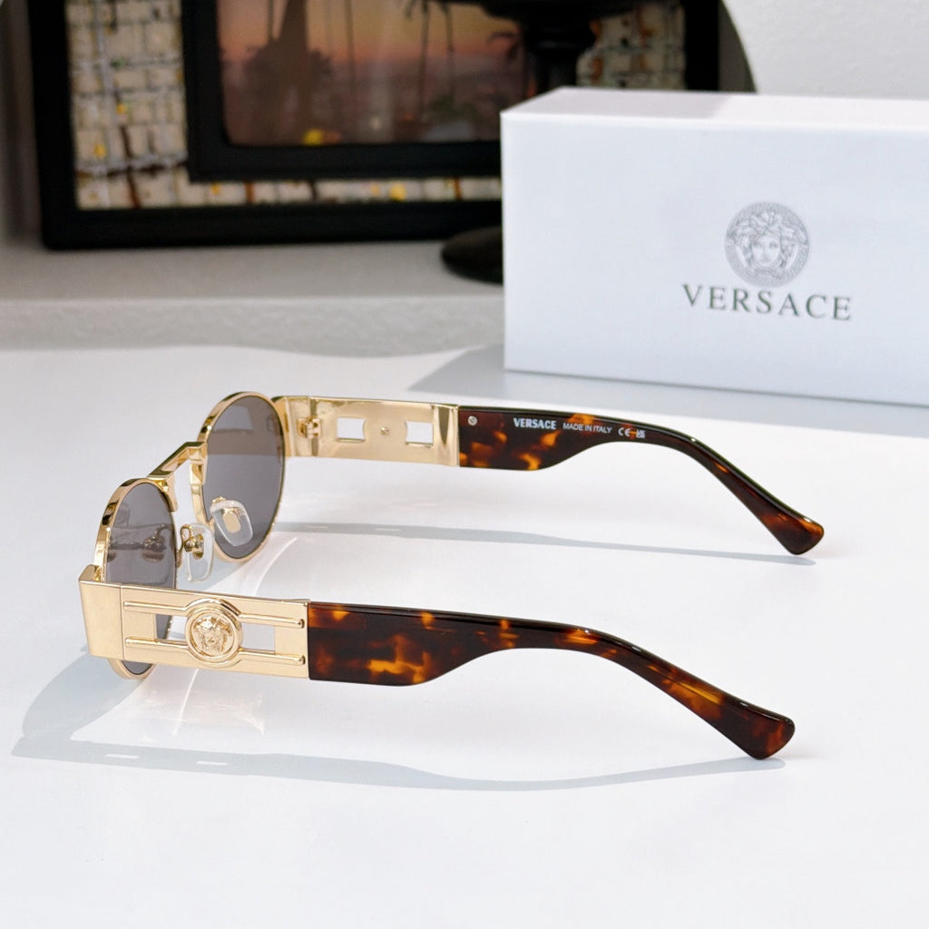 Versace sunglasses, gold-tone frames, round dark lenses, tortoiseshell temple tips