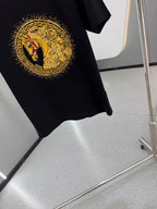 Versace T-shirt front with gold circular emblem and red accents on dark navy fabric