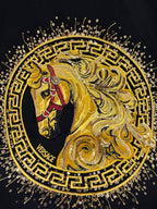 Versace T-shirt close-up of gold lion and horse graphic with “VERSACE” text