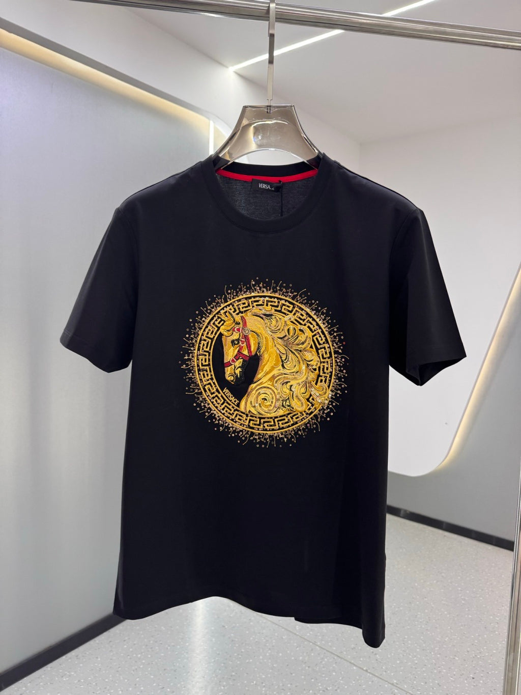 Versace T-shirt in dark navy with gold and red circular horse graphic on front