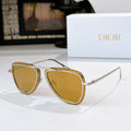 Dior sunglasses with gold frame and amber tinted lenses, cat-eye shape