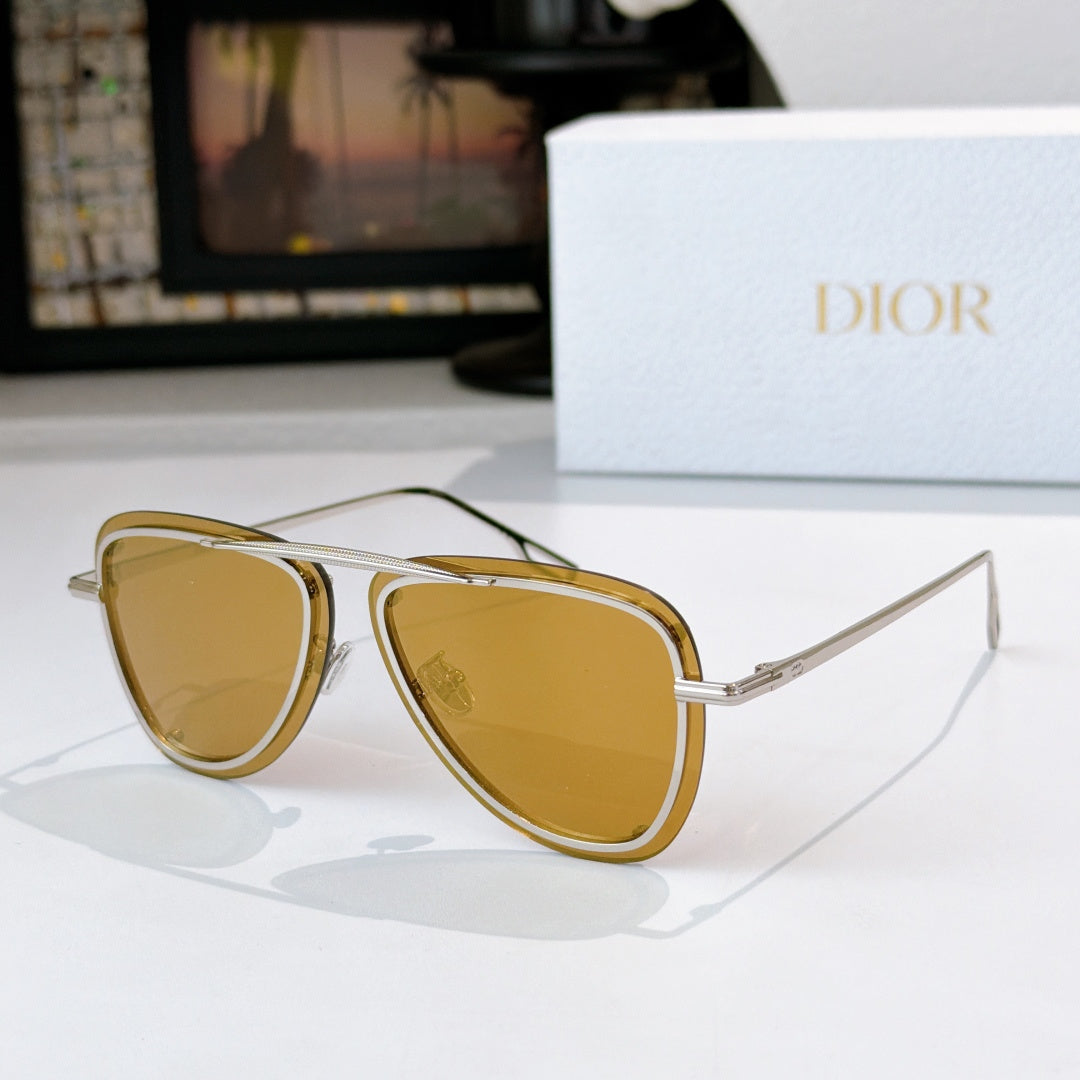 Dior sunglasses with gold frame and amber tinted lenses, cat-eye shape
