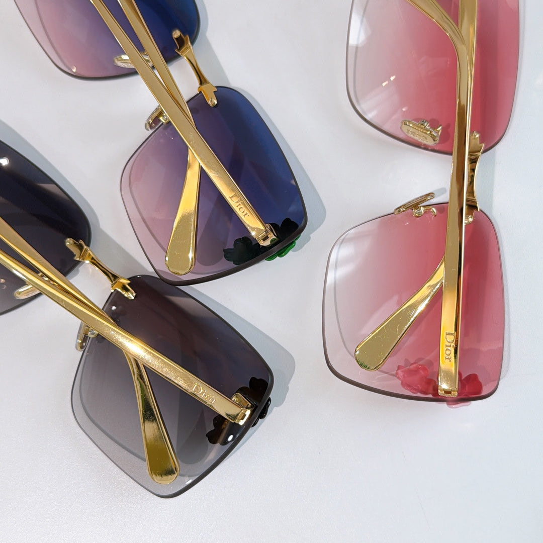 Close-up of Dior gold sunglasses temples with pink and blue gradient lenses