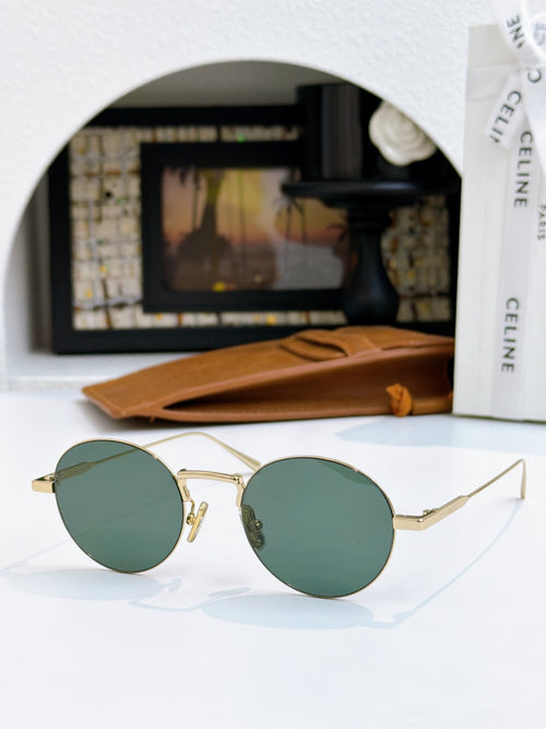 Round gold-frame sunglasses with dark green lenses and thin metal arms.