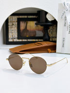 Gold round sunglasses with warm brown lenses and thin metal temples
