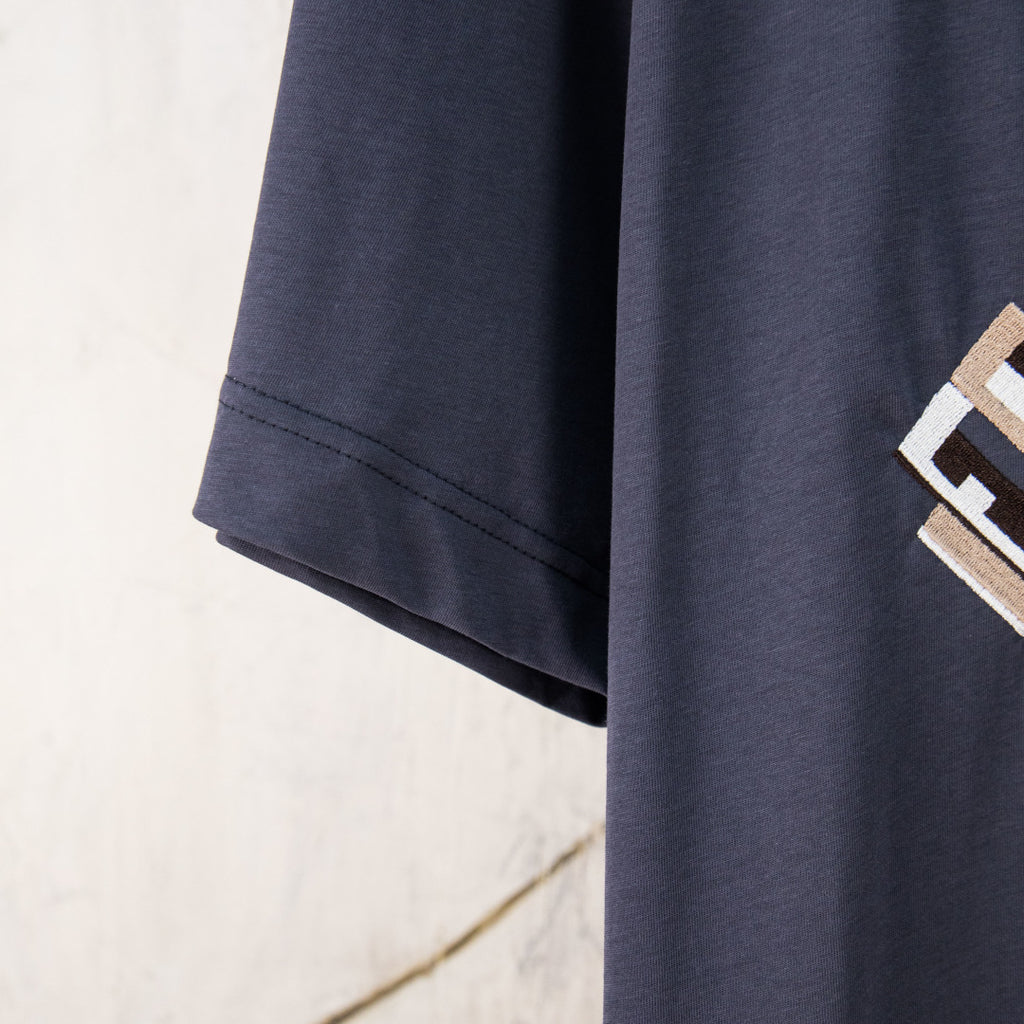 Dark blue short-sleeve T-shirt sleeve hem with visible stitching
