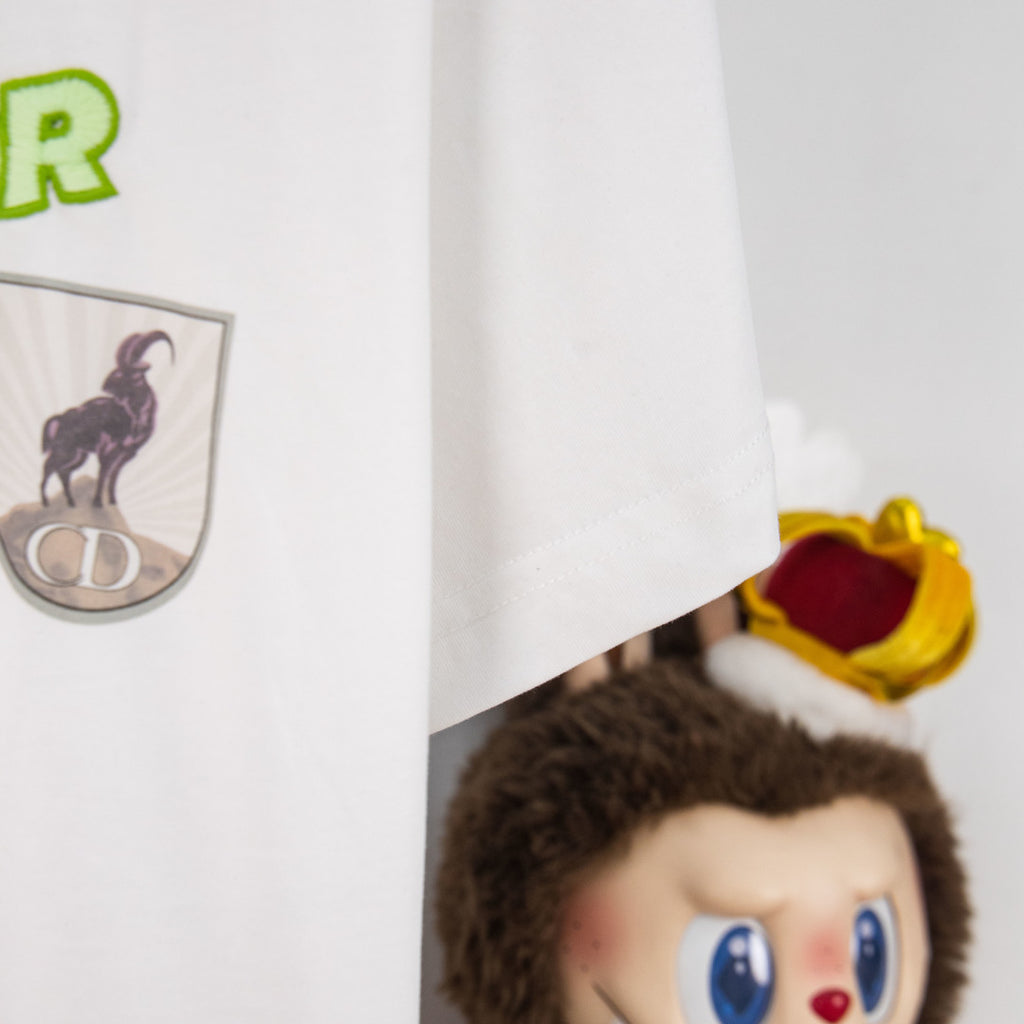 White Dior T-shirt sleeve and hem detail with patch graphic partly visible