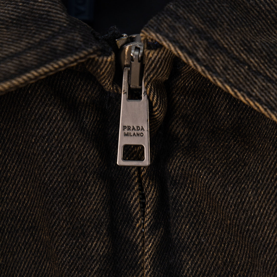Zip pull with PRADA MILANO text on dark-brown jacket