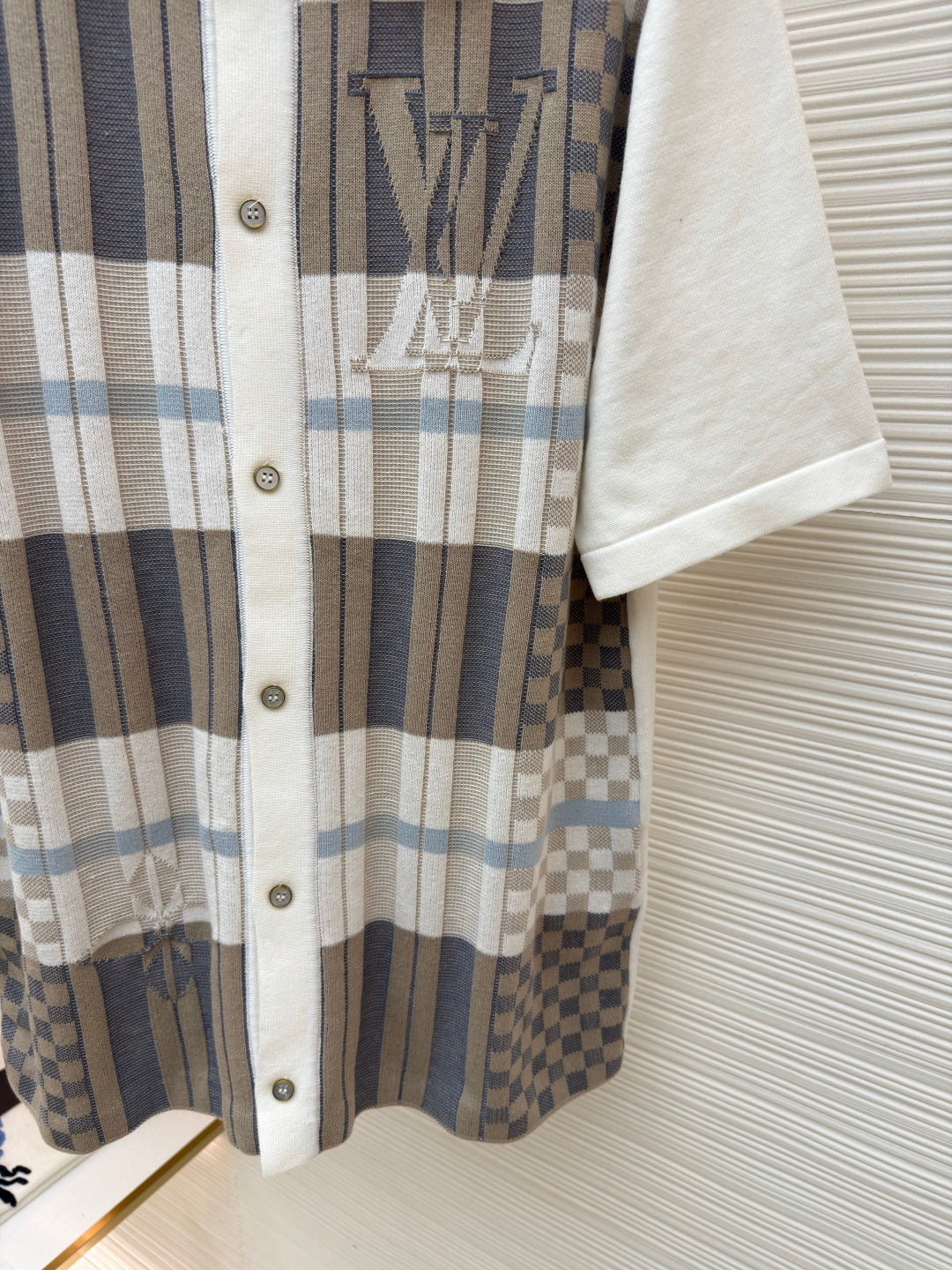 Louis Vuitton short-sleeve button-up shirt detail, plaid panel with monogram print