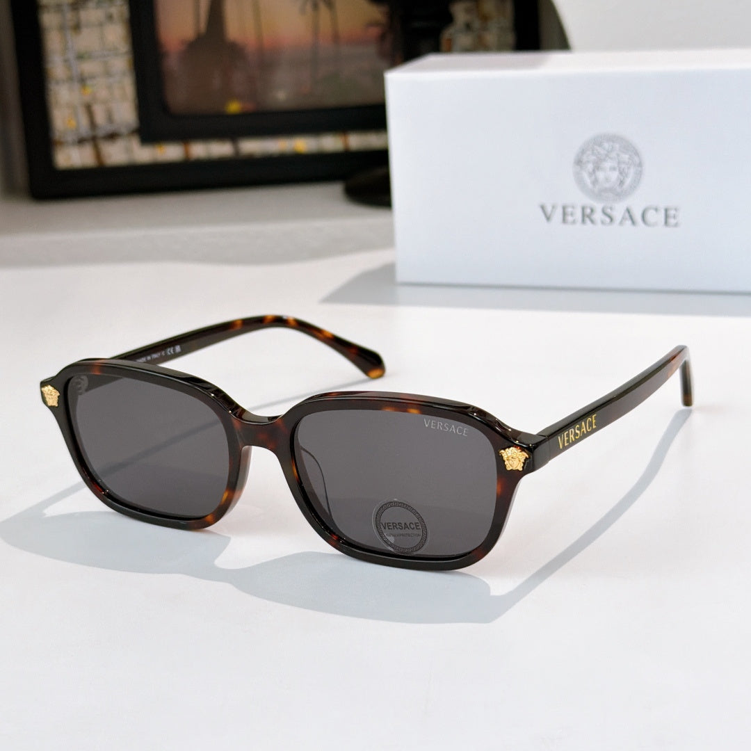 Versace sunglasses with tortoiseshell frame and dark tinted lenses, gold temple accents