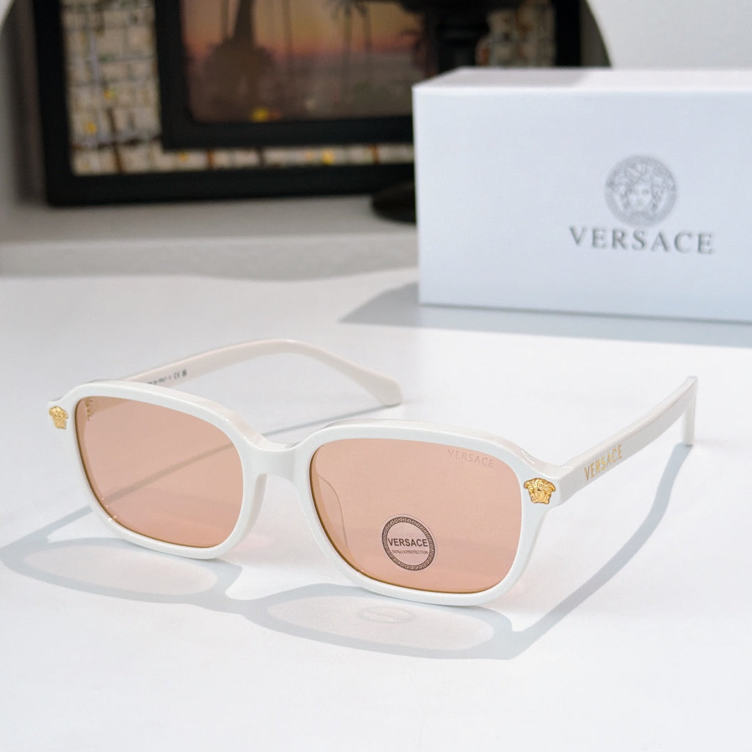 Versace sunglasses with white frame and pink tinted lenses, gold temple accents