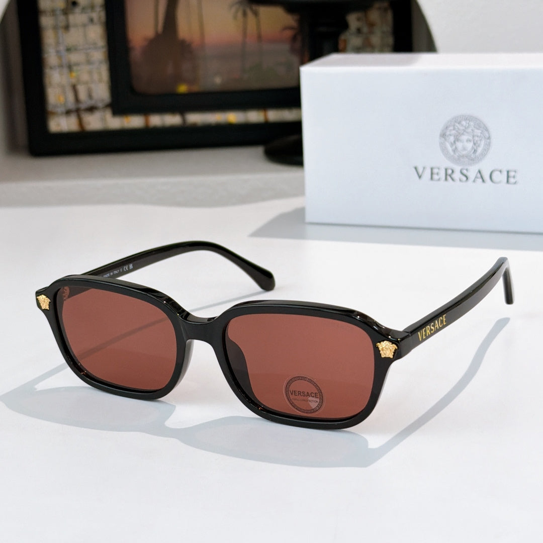 Versace sunglasses with black frame and brown tinted lenses, gold temple accents