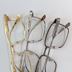 Cartier glasses set with gold, silver, and gray frames on clear lens fronts