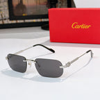 Gold-rimmed sunglasses, side view, with dark gray lenses and black arms, metal hinges