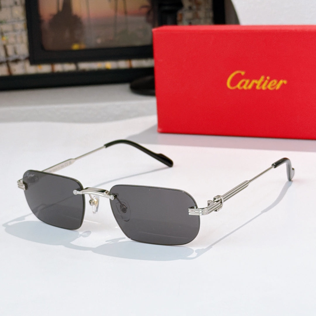 Gold-rimmed sunglasses, side view, with dark gray lenses and black arms, metal hinges