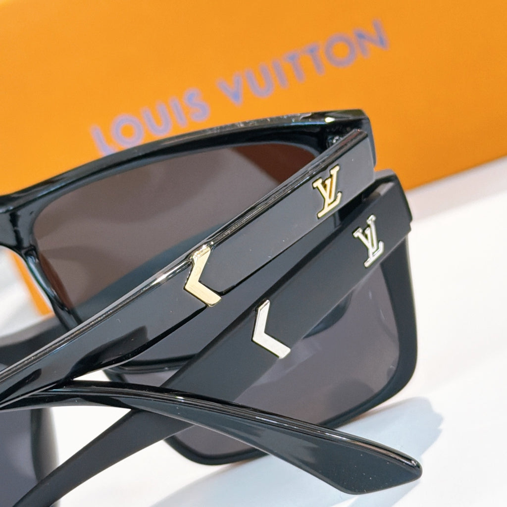 Black sunglasses with gold LV logo on temples and dark lenses