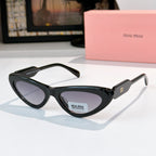 MiuMiu cat-eye glasses with dark frame and pale lenses