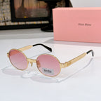 Round sunglasses with gold-tone frame and pink tinted lenses, dark temples